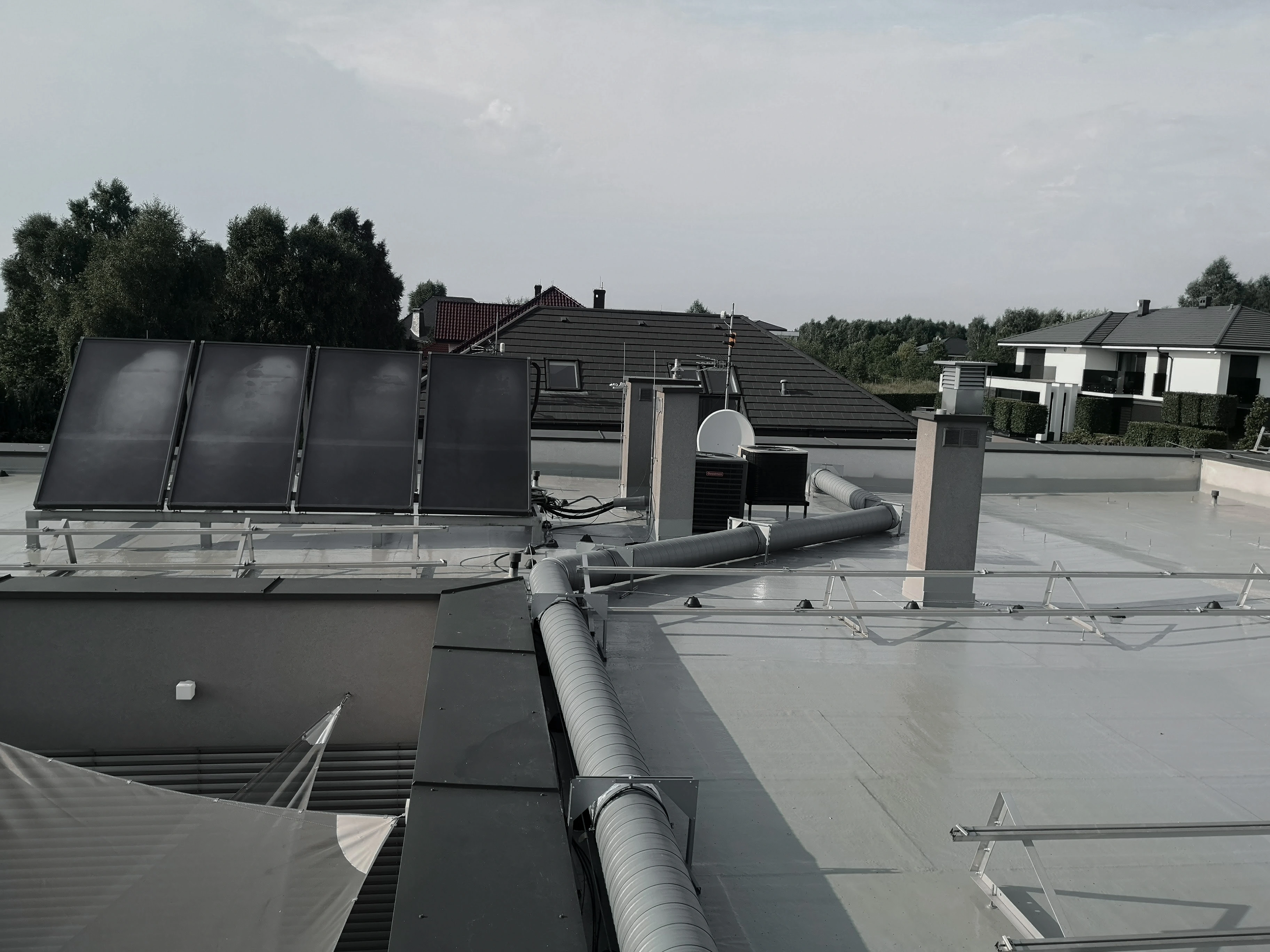 Flat roof with waterproofing, chimneys and service penetrations