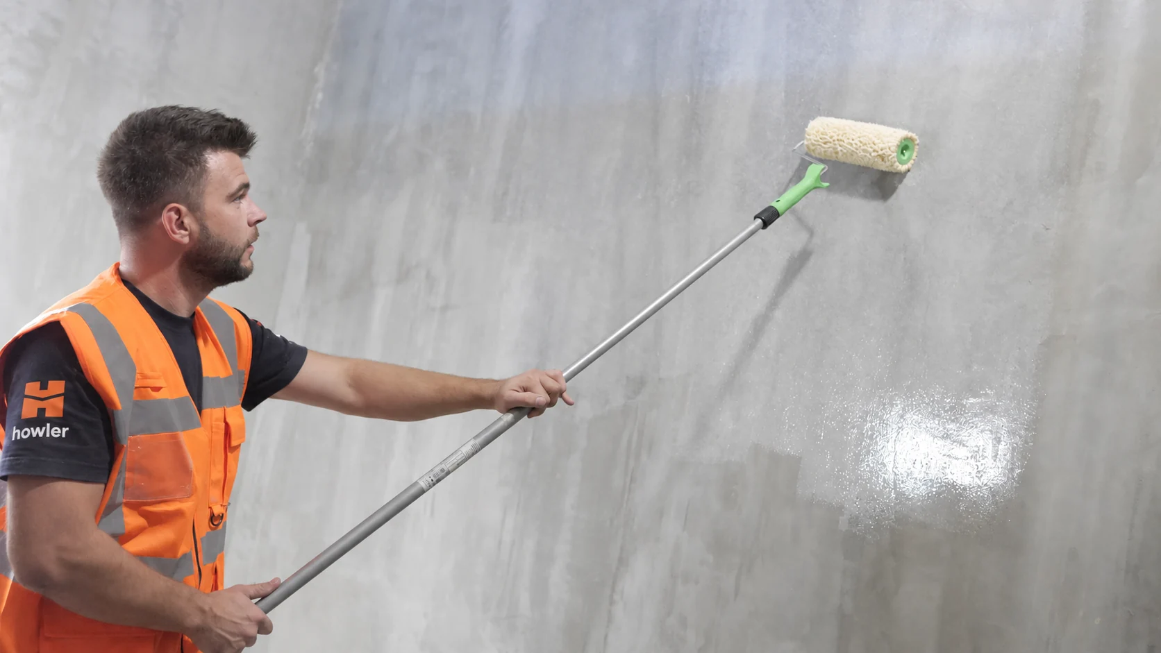 Applying primer to a basin wall with a roller before the subsequent layers.