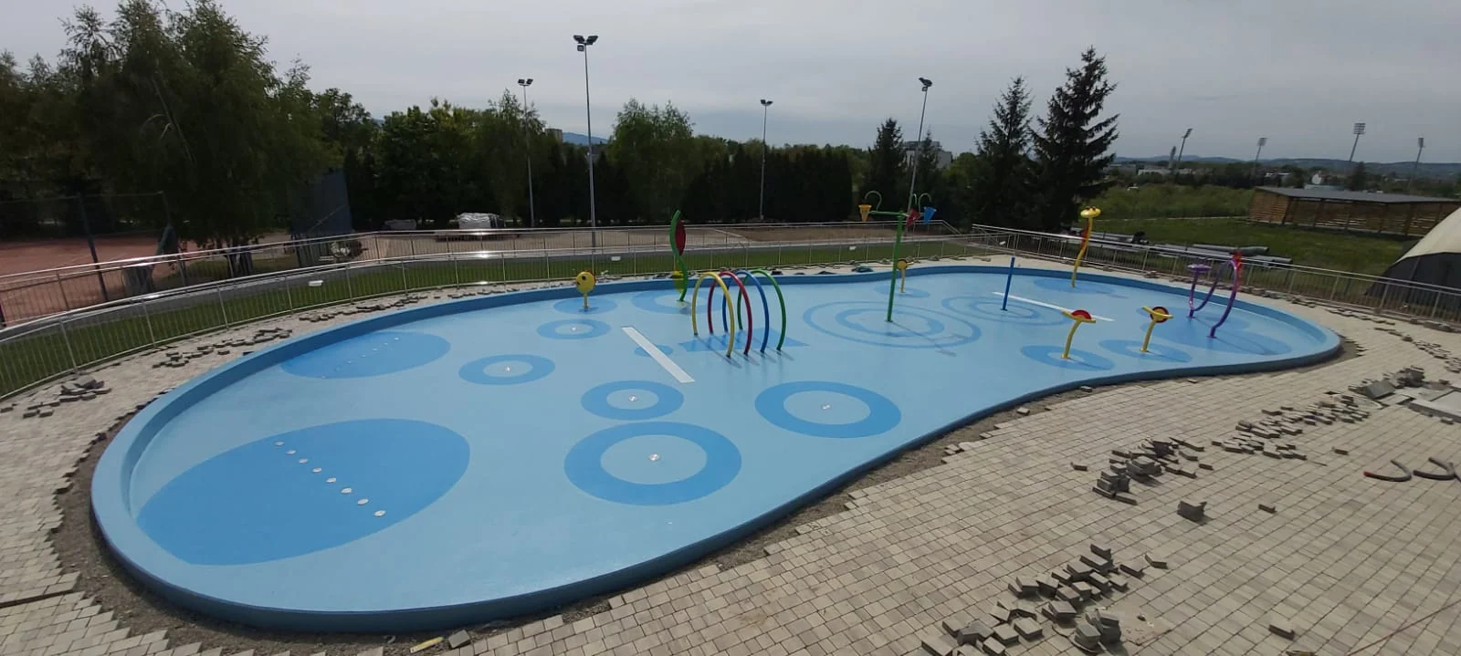 A blue basin with curved edges in a water play area.